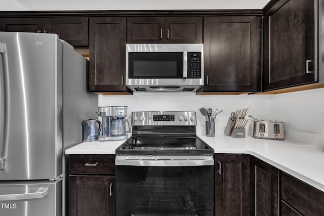 kitchen with light countertops, stainless steel appliances, and dark brown cabinetry