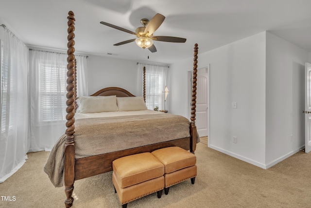 bedroom with a ceiling fan, baseboards, light colored carpet, and visible vents