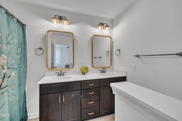full bath featuring double vanity and a sink