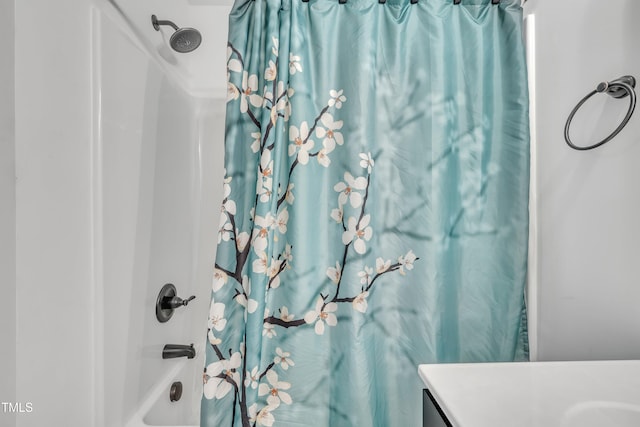 bathroom featuring vanity and shower / bathtub combination with curtain