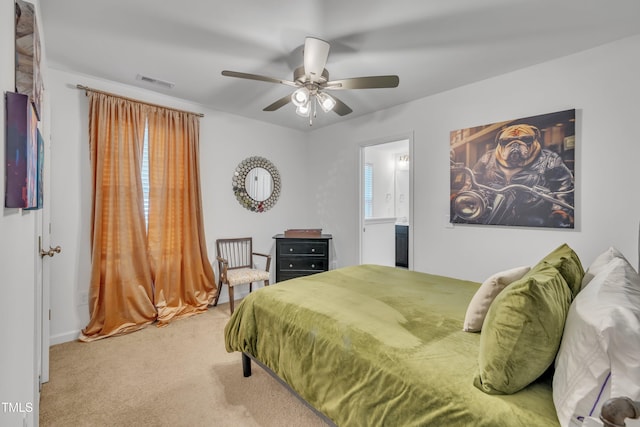 carpeted bedroom featuring visible vents, a ceiling fan, baseboards, and connected bathroom