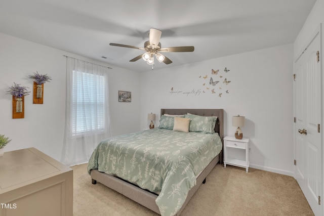 bedroom with carpet floors, baseboards, a ceiling fan, and visible vents
