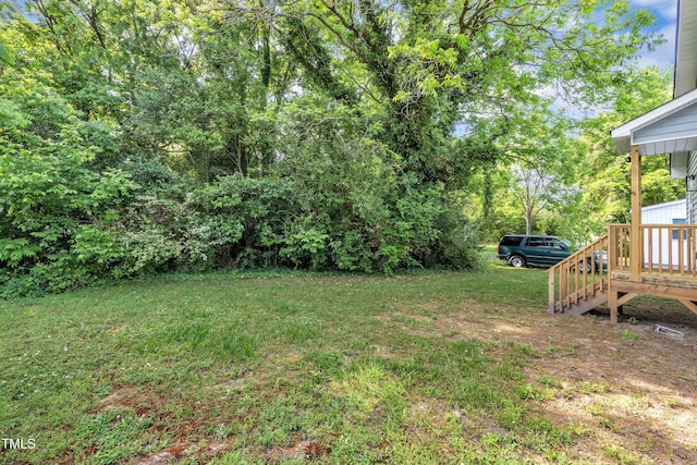 view of yard with stairs and a wooden deck