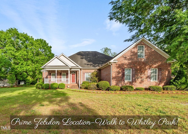 406 N Wakefield St, Zebulon, NC 27597 - view of front of property with covered porch, brick siding, and a front lawn