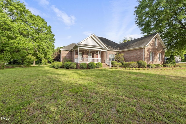 406 N Wakefield St, Zebulon, NC 27597 - view of front of property with a porch, brick siding, and a front lawn