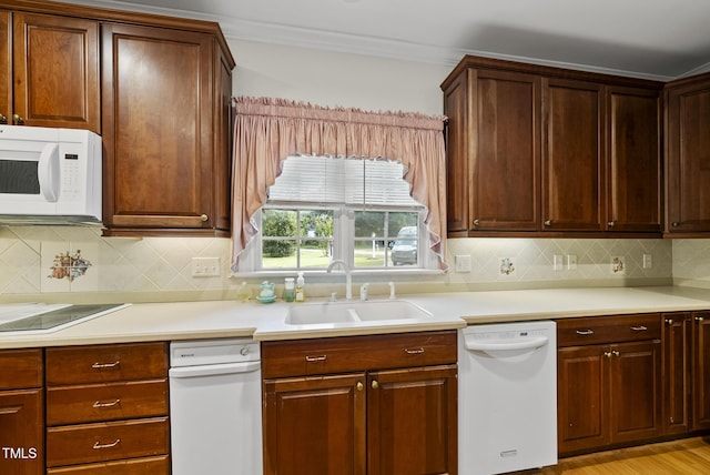 406 N Wakefield St, Zebulon, NC 27597 - kitchen with white appliances, a sink, light countertops, ornamental molding, and backsplash