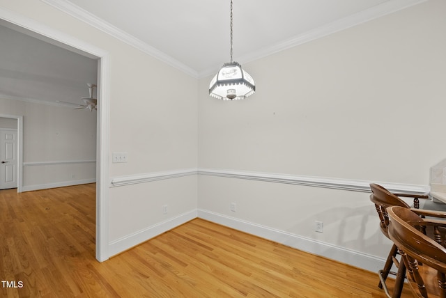 406 N Wakefield St, Zebulon, NC 27597 - unfurnished dining area featuring light wood-type flooring, ornamental molding, baseboards, and a ceiling fan