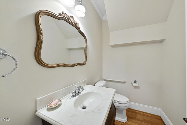 406 N Wakefield St, Zebulon, NC 27597 - bathroom with crown molding, toilet, wood finished floors, baseboards, and vanity
