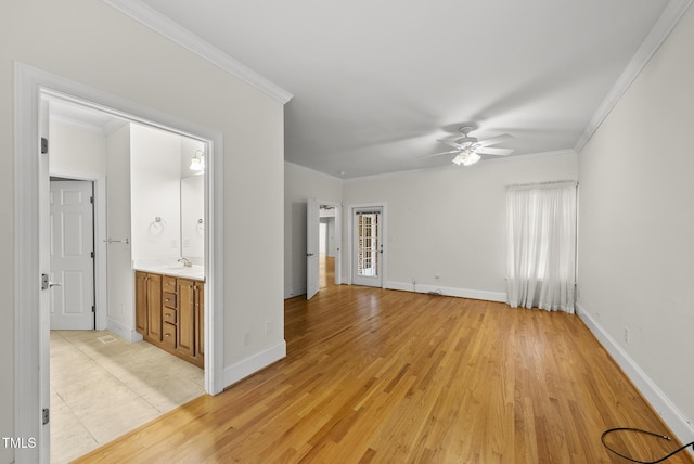 406 N Wakefield St, Zebulon, NC 27597 - empty room featuring a ceiling fan, crown molding, a sink, baseboards, and light wood-type flooring