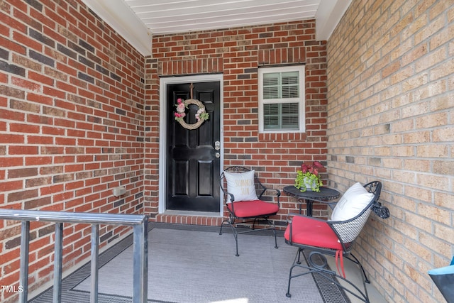 property entrance featuring brick siding