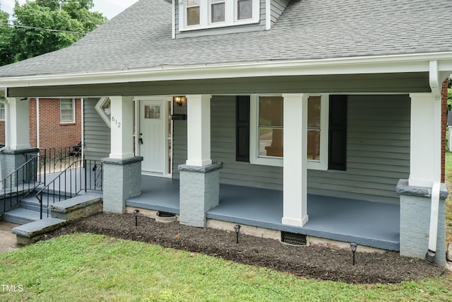 property entrance with a shingled roof and a porch
