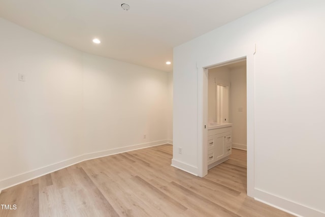 unfurnished room with light wood-type flooring, baseboards, and recessed lighting