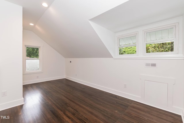 additional living space featuring vaulted ceiling, baseboards, dark wood-style flooring, and recessed lighting