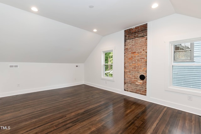 bonus room featuring lofted ceiling, dark wood-style flooring, baseboards, and recessed lighting