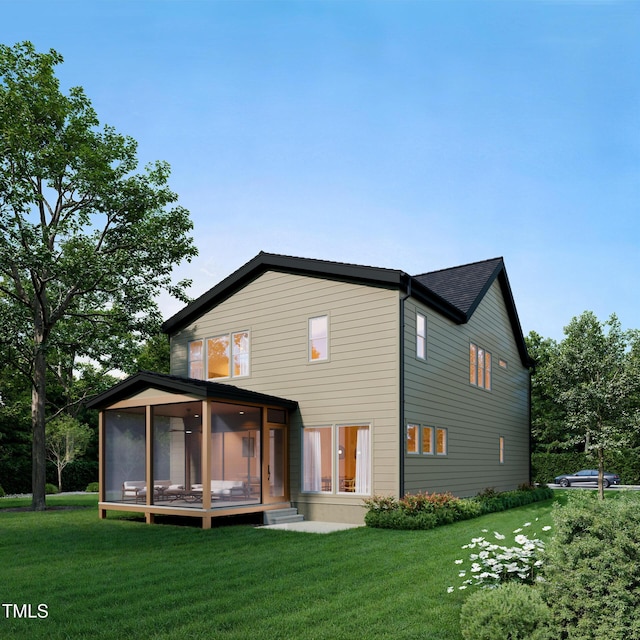 rear view of house featuring a yard and a sunroom