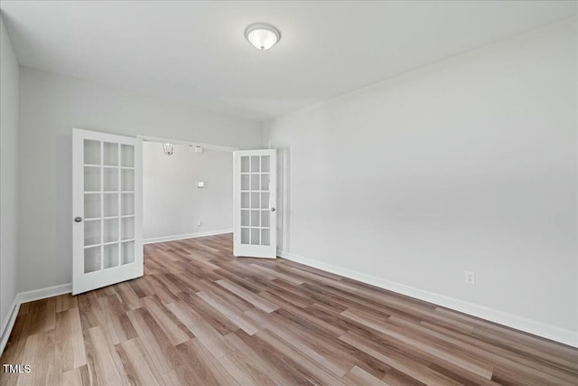1005 Whispering Creek Ct, Knightdale, NC 27545 - unfurnished room with baseboards, french doors, and wood finished floors