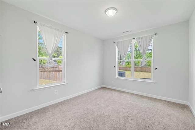 1005 Whispering Creek Ct, Knightdale, NC 27545 - carpeted spare room with visible vents, baseboards, and a wealth of natural light