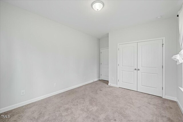 1005 Whispering Creek Ct, Knightdale, NC 27545 - unfurnished bedroom featuring baseboards, carpet floors, and a closet