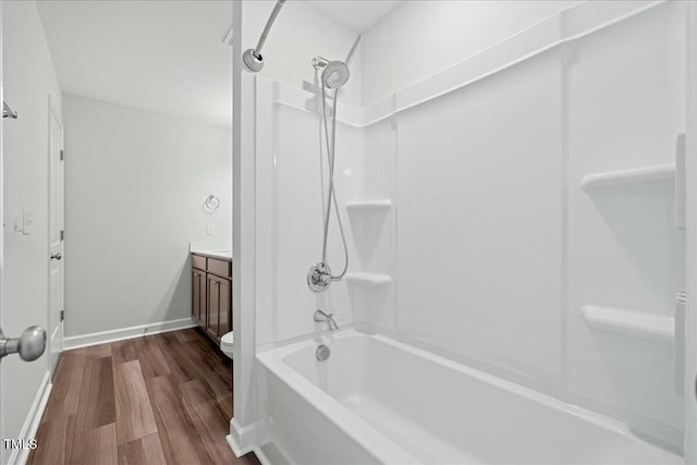 1005 Whispering Creek Ct, Knightdale, NC 27545 - full bathroom featuring wood finished floors, toilet, vanity, tub / shower combination, and baseboards
