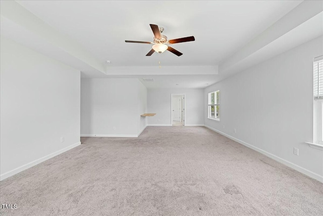 1005 Whispering Creek Ct, Knightdale, NC 27545 - carpeted empty room with baseboards, a ceiling fan, and a tray ceiling