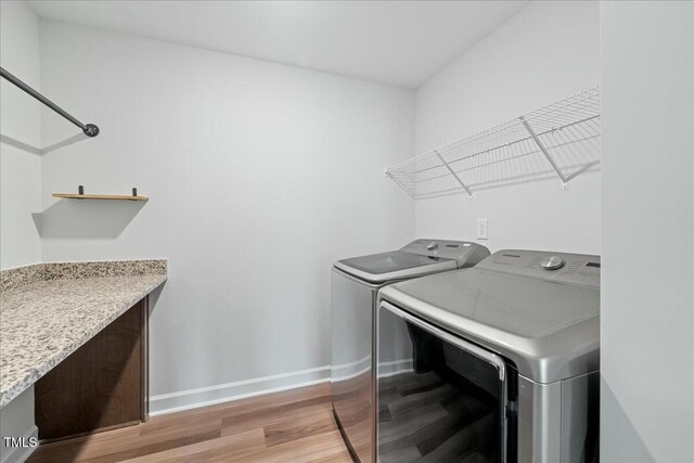 1005 Whispering Creek Ct, Knightdale, NC 27545 - washroom featuring baseboards, independent washer and dryer, laundry area, and light wood-type flooring