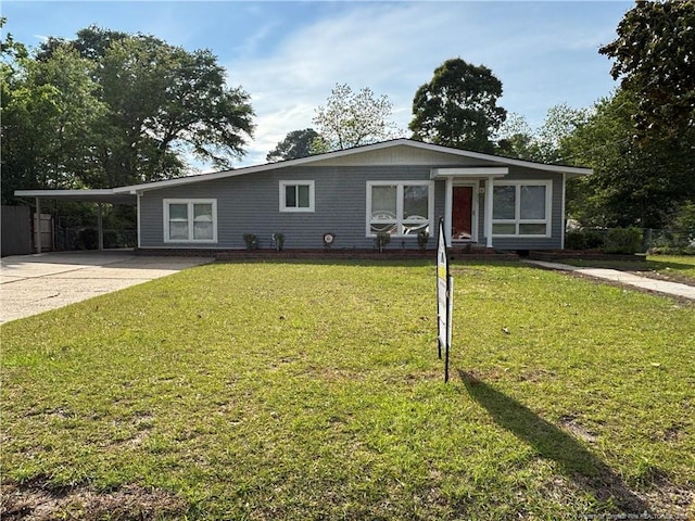single story home featuring an attached carport, a front yard, and concrete driveway