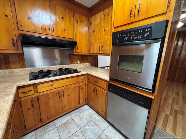 kitchen with light countertops, brown cabinets, and stainless steel appliances