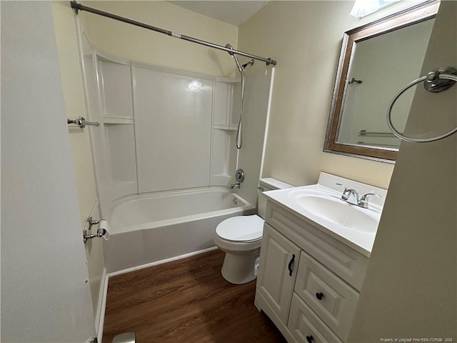 bathroom featuring shower / bathtub combination, wood finished floors, vanity, and toilet