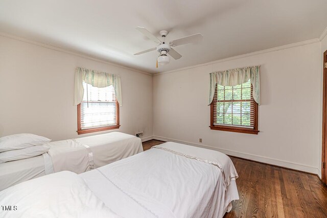 bedroom featuring baseboards, ornamental molding, a ceiling fan, and wood finished floors