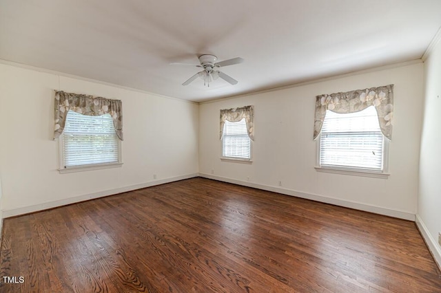 unfurnished room featuring baseboards, ornamental molding, a ceiling fan, and wood finished floors