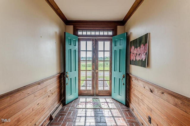 doorway featuring crown molding, wainscoting, brick floor, and french doors