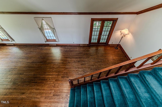 stairs featuring crown molding, baseboards, wood finished floors, and visible vents