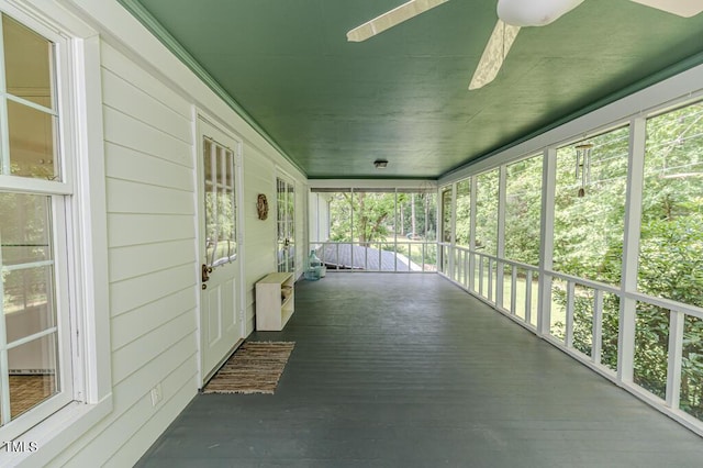 unfurnished sunroom with a ceiling fan