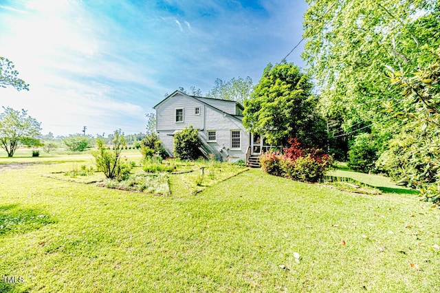 rear view of house featuring a lawn