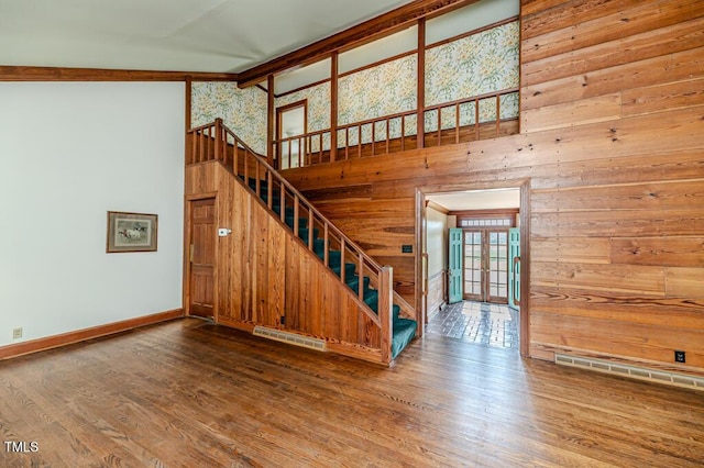 stairway with baseboards, visible vents, french doors, and wood finished floors
