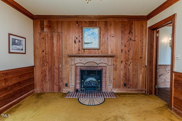 unfurnished living room featuring carpet flooring, wood walls, and ornamental molding