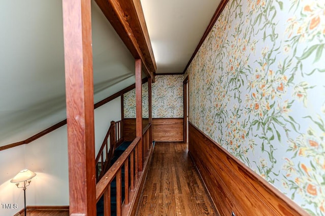 corridor with crown molding, dark wood-style flooring, wainscoting, and wallpapered walls