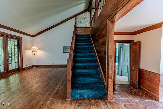 stairs featuring vaulted ceiling, ornamental molding, and french doors