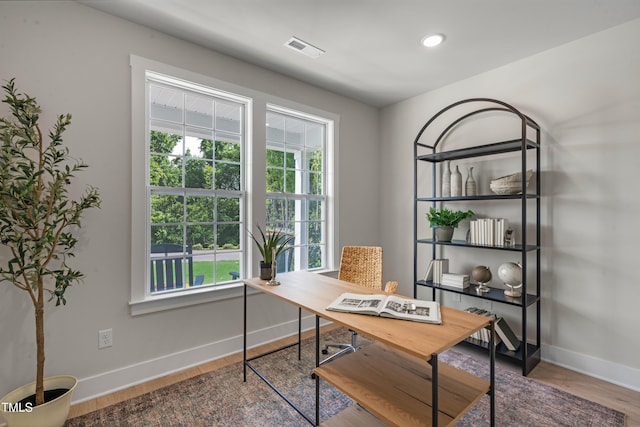 office space with baseboards, recessed lighting, wood finished floors, and visible vents