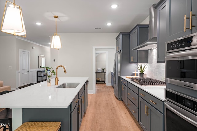 kitchen with light countertops, stainless steel appliances, decorative backsplash, and a sink