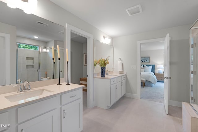 full bath with visible vents, a sink, connected bathroom, and a shower stall