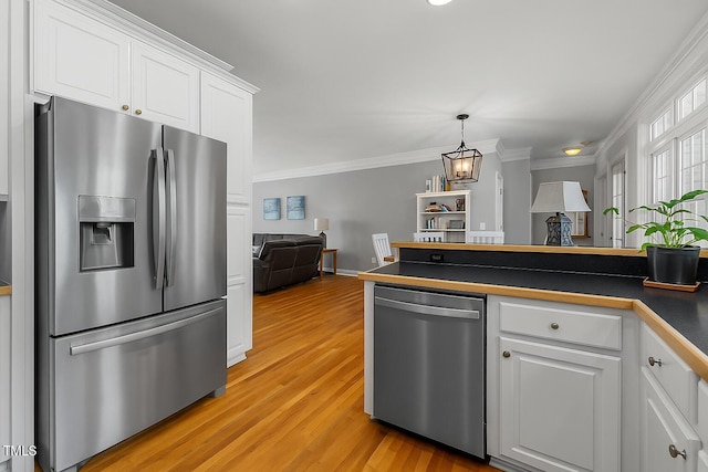 226 Fletcher Ridge Rd, Timberlake, NC 27583 - kitchen featuring stainless steel appliances, dark countertops, white cabinetry, light wood-type flooring, and crown molding