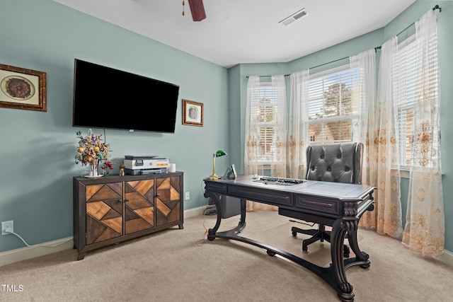 home office with carpet floors, baseboards, and a ceiling fan