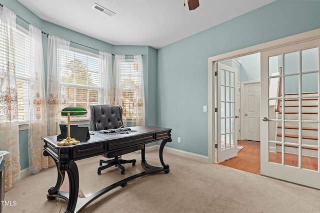 carpeted home office featuring baseboards and ceiling fan