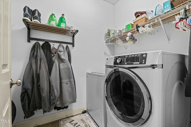 laundry area with washing machine and clothes dryer