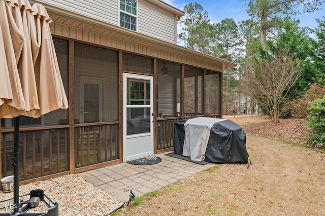 view of patio featuring a sunroom and a grill