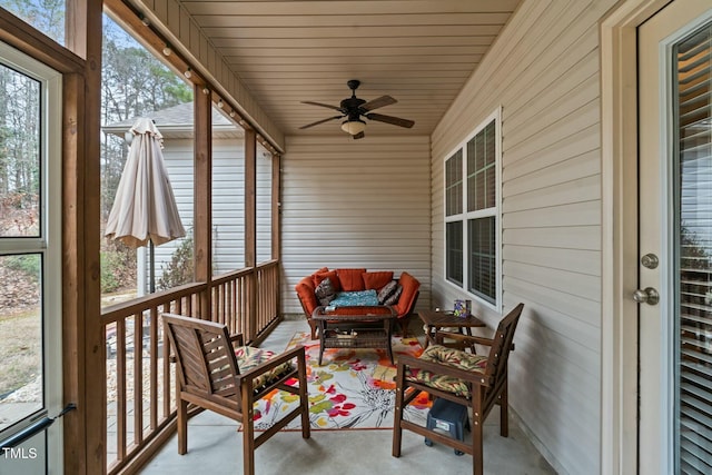 sunroom / solarium with a ceiling fan and outdoor lounge area