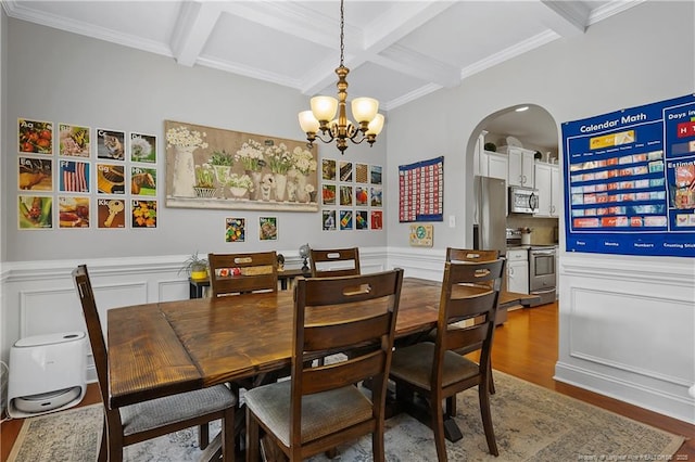 dining area featuring coffered ceiling, wood finished floors, beam ceiling, a chandelier, and arched walkways