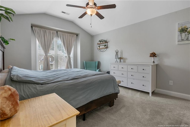 carpeted bedroom featuring lofted ceiling, baseboards, and ceiling fan