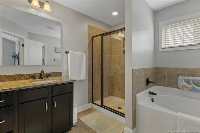 full bathroom featuring a stall shower, vanity, a bath, and tile patterned flooring